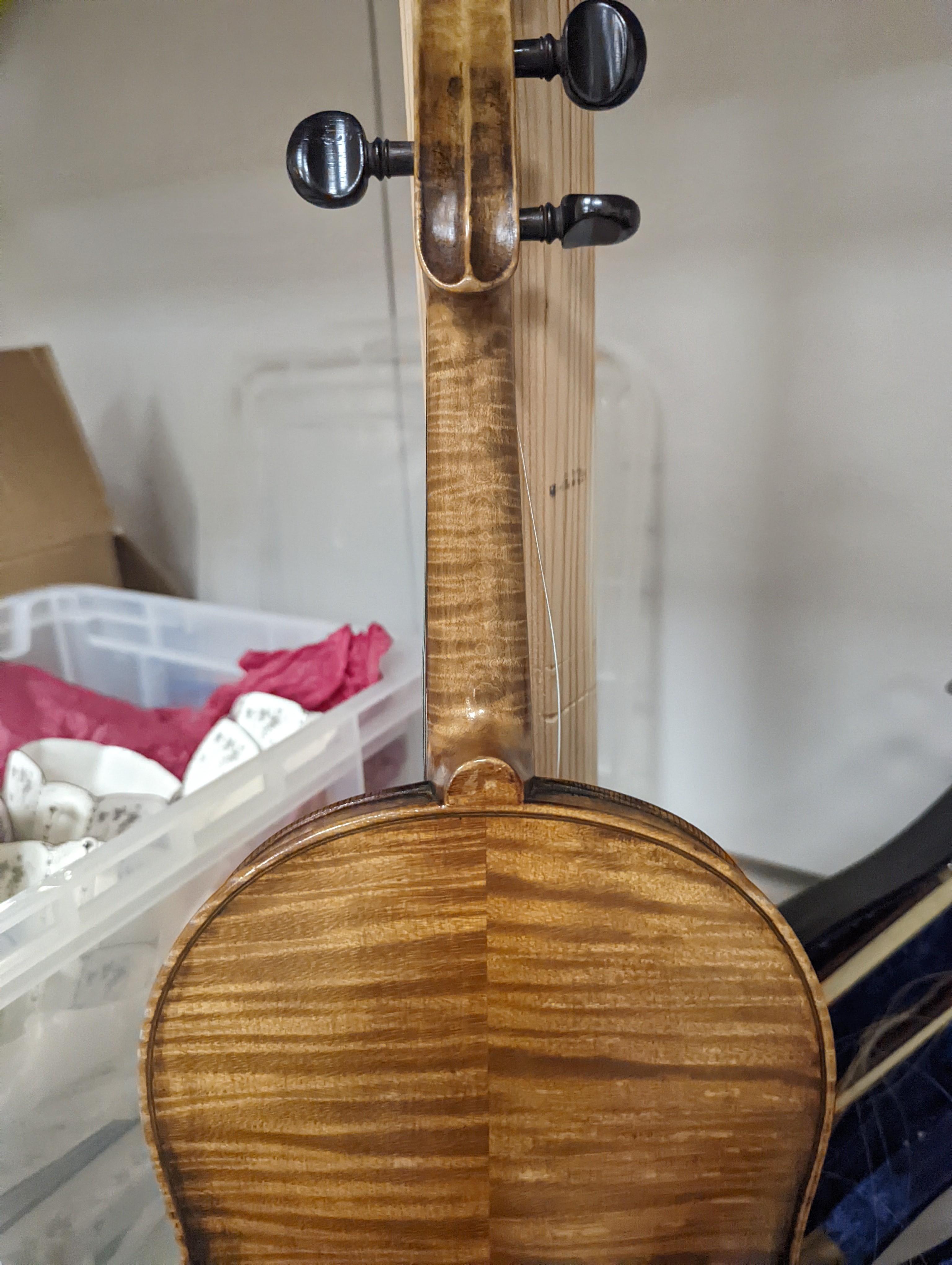 An early 20th century French or English violin with two bows, each stamped